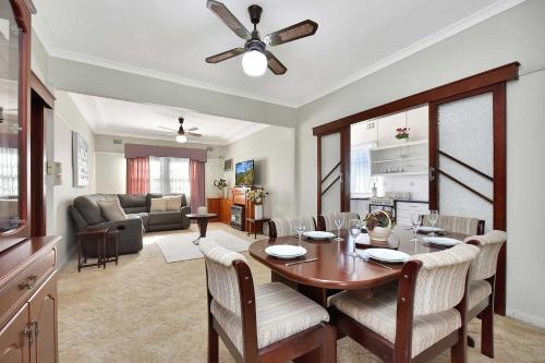 a dining room and living room with a table and chairs at Morpeth Cottage in Morpeth