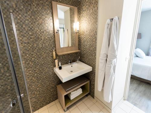 a bathroom with a sink and a shower at Tranquil Apartment with Pool Access in Bagnoles de l'Orne