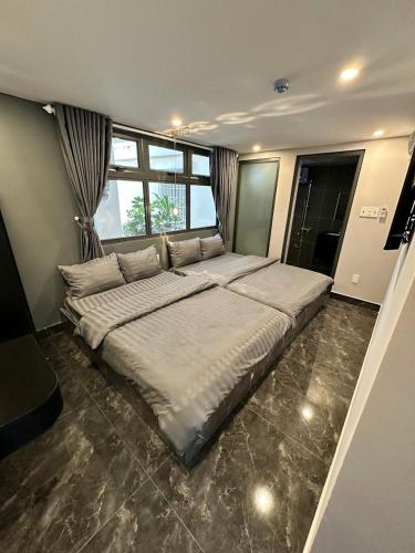 a large bed in a room with a large window at Dalat Family Center in Da Lat