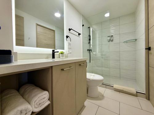 a bathroom with a shower and a sink and a toilet at Panoramic view apartment with Pool and Rooftop in San Salvador