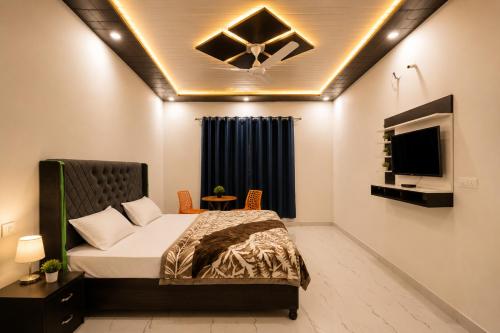a bedroom with a bed and a tv on the ceiling at Hotel Brothers Elite Stay in Panchkula