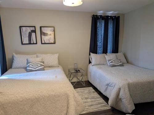 a bedroom with two beds and a window at Clifton Hill Suite 2202 in Niagara Falls