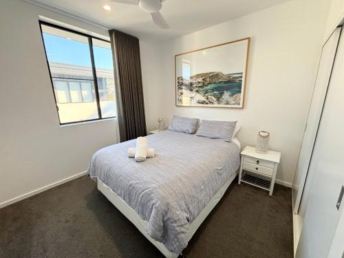 a bedroom with a bed and a window at Arizons in South West Rocks