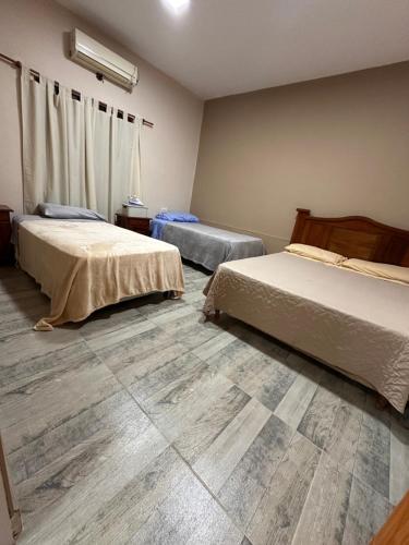 a bedroom with two beds and a tiled floor at Finca Alta Gracia La Banda in La Banda
