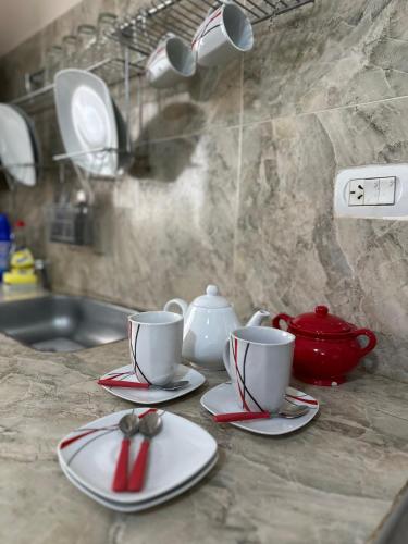 a counter with two cups and a tea pot on it at Finca Alta Gracia La Banda in La Banda