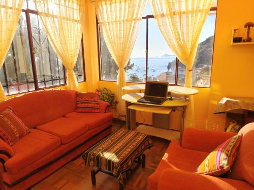a living room with a couch and a laptop on a table at Leo in Copacabana