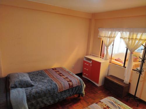 a bedroom with a bed and a dresser and a mirror at Leo in Copacabana