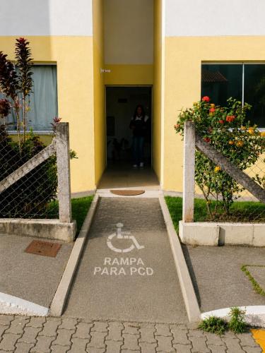a person standing in the doorway of a building at Meu Aconchego - Araruama 2 quartos - Vaga- Wi-Fi in Araruama