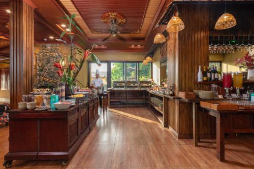 a large kitchen with wooden floors and a counter top at Pu Luong EcoLuxe Resort & Spa in Pu Luong