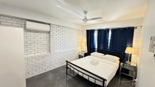 a bedroom with a bed with a black bed frame at Pool House with 3 BDR 2 AC in Marsden