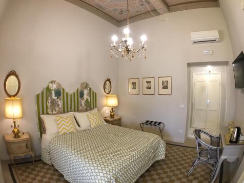 a bedroom with a bed and a chandelier at B&B Theodora in Frascati