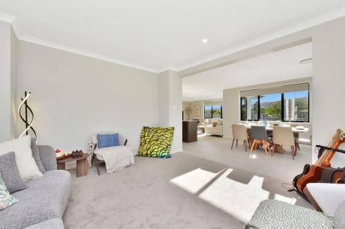 a living room with a couch and a table at Mount View Escape at Millfield in Millfield