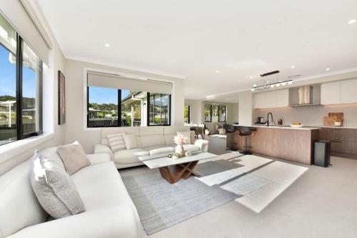 a living room with a white couch and a table at Mount View Escape at Millfield in Millfield