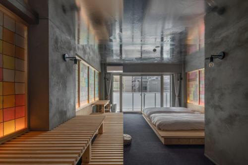 a bedroom with two beds and windows in it at MN Building - Vacation STAY 11196 in Nagoya