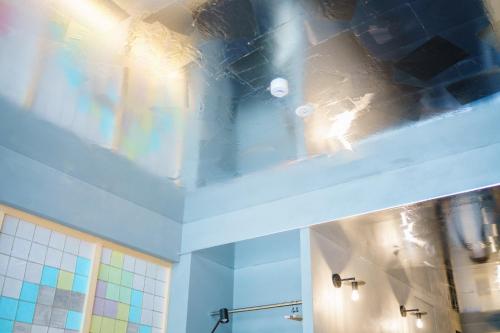 two pictures of a bathroom with a shower and a sink at MN Building - Vacation STAY 11196 in Nagoya
