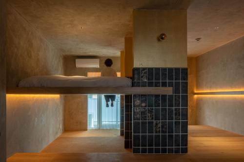 a room with a bed and a person standing in a bedroom at MN Building - Vacation STAY 11199 in Nagoya