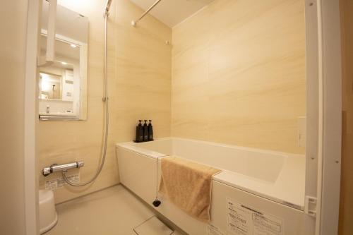 a bathroom with a bath tub and a shower at MN Building - Vacation STAY 11199 in Nagoya