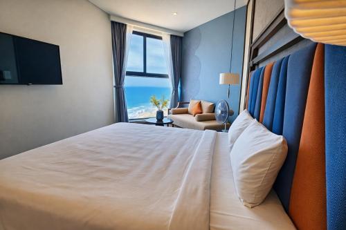 a bedroom with a large white bed and a couch at Mandala Pearl Resort in Phan Thiet