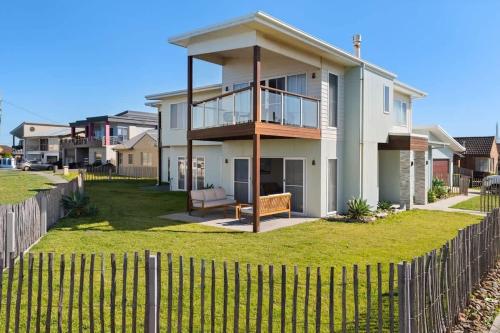a large house with a fence in front of it at Sea Sand and Serenity at Stockton - Stunning Sophistication in Stockton