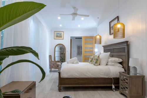 a bedroom with a bed and a potted plant at The Lake Palace in Murrays Beach