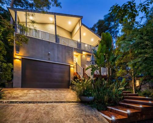 a house with a garage door and some stairs at The Lake Palace in Murrays Beach