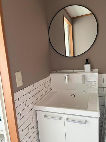 a bathroom with a white sink and a mirror at Shell Beach Hamanako - Vacation STAY 14730 in Hamamatsu
