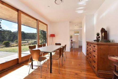 a dining room with a table and chairs at The Parsons Retreat in Rothbury