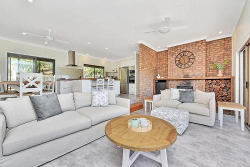a living room with a couch and a table at Kookaburra Range in Greta