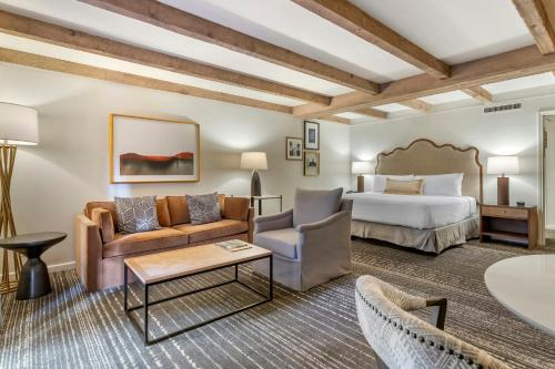 a hotel room with a king sized bed and a couch at Omni La Mansion del Rio in San Antonio