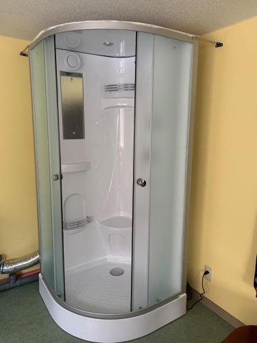 a glass shower stall in the corner of a room at Formosa Hakodate - Vacation STAY 17455 in Hokuto