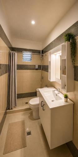 a bathroom with a white sink and a toilet at Beyond Island Resort in Moalboal