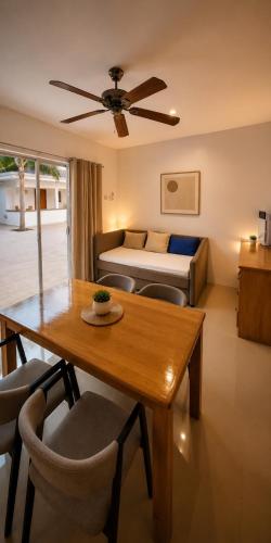 a living room with a table and a bed at Beyond Island Resort in Moalboal