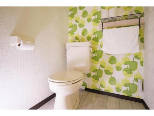 a white toilet in a bathroom with a towel at R Hotel - Vacation STAY 19689 in Chiba