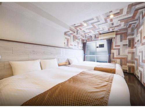a hotel room with two beds in it at R Hotel - Vacation STAY 19692 in Chiba
