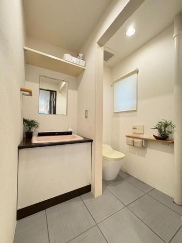 a bathroom with a toilet and a sink at Frontier First Building - Vacation STAY 19759 in Kagoshima