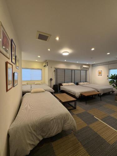 a room with four beds in a room at Frontier First Building - Vacation STAY 19759 in Kagoshima