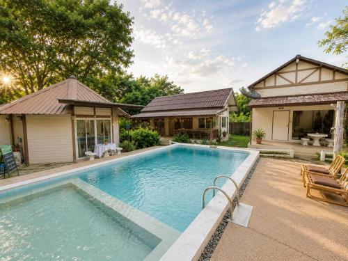 a swimming pool in the backyard of a house at The Scarecrow House in Ban Doem Bang (1)