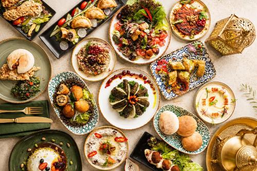 a table with many plates of food on it at Centara Grand at CentralWorld in Bangkok