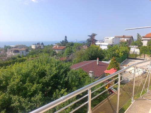 a person sitting on a balcony overlooking a city at Къща за гости ,,Лозница ГТ'' in Varna City