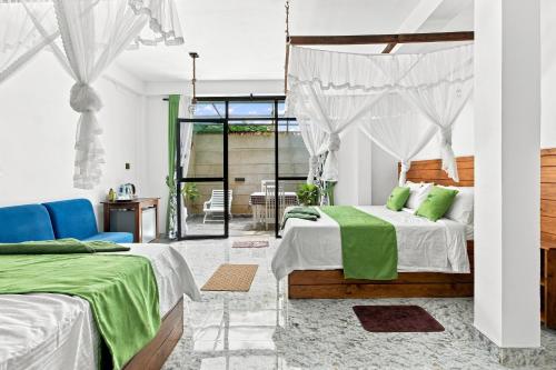 a bedroom with two beds with green pillows at The Canapy Nest Ella in Ella