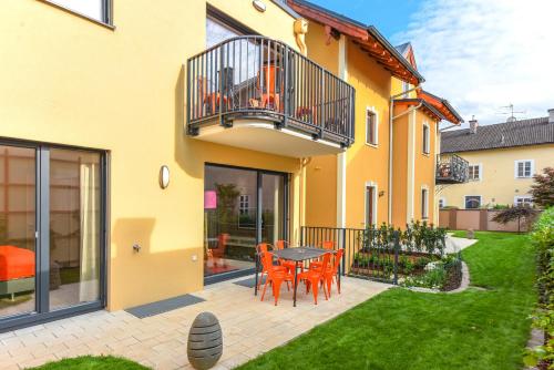 a house with a patio with a table and chairs at Villa Salzburg by Welcome to Salzburg in Salzburg