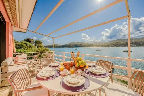 a table on a balcony with a view of the water at Ranco Villa - 14006 in Ranco