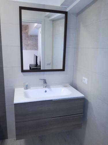 a bathroom with a sink and a mirror at Domus Rosae in Scicli