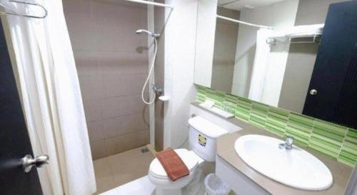 a bathroom with a sink and a toilet and a mirror at U Style Hotel in Ban Phang Khwang Tai
