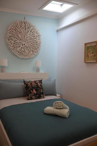 a bedroom with a bed with a towel on it at Far View - Pets, Linen, Wi-Fi, Netflix, Caravan, EV in Venus Bay