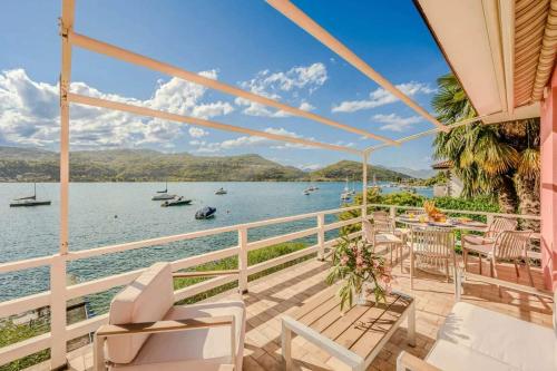 a house with a balcony with a view of the water at Ranco Villa - 14006 in Ranco