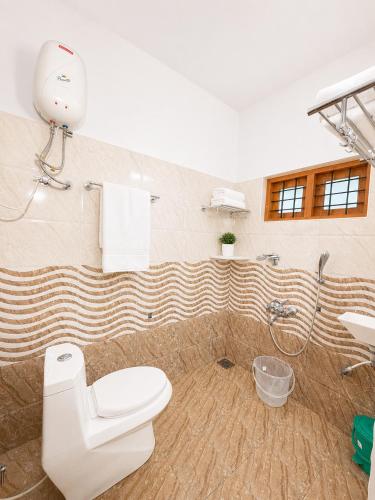a bathroom with a toilet and a shower at Mist & Meadows Premium VIlla By STAYVA in Munnar