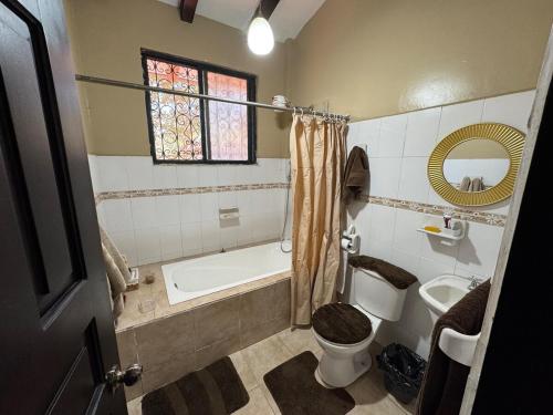a bathroom with a tub and a toilet and a sink at MiniFinquita Ibarra in Ibarra