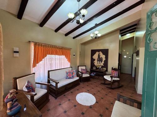 a large living room with couches and a table at MiniFinquita Ibarra in Ibarra