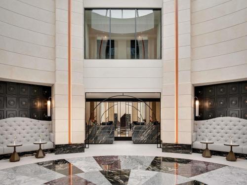 a lobby with couches and tables in a building at Fairmont Windsor Park in Windsor